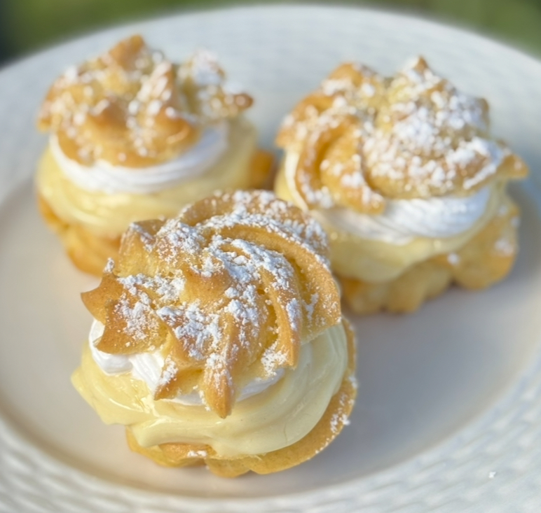 Cream puffs filled with cream and dusted with powdered sugar